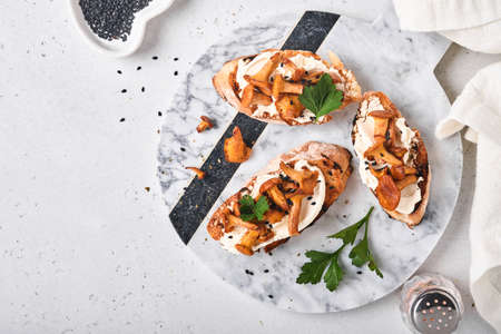 Chanterelle sandwiches with cheese. Open faced sandwich with creamy cheese, seasonings and pepper...