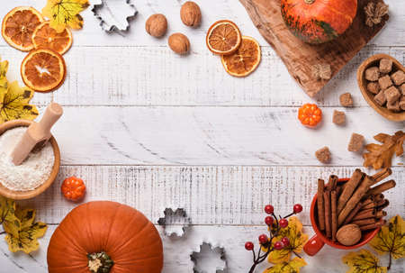 Pumpkin and food ingredients, spices, cinnamon and kitchen utencil on white rustic wooden...