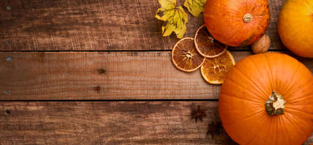 Pumpkin. Autumn food background with cinnamon, nuts and seasonal spices on rustic background....