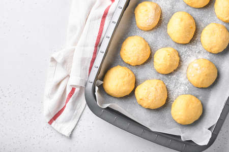 Raw yeast dough balls background in frying pan before baking. Concept home baking bread, buns or...