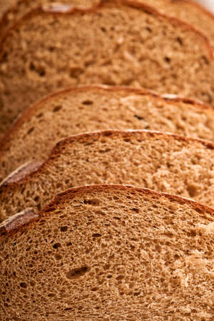 Fresh homemade rye bread. Traditional spelled sourdough bread cut into slices on a rustic wooden...