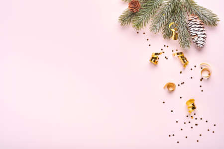Christmas composition. Christmas pink gift or present box, gold baubles and confetti on pink...