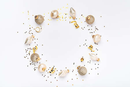 Christmas composition. Christmas gold ball made of balls and confetti on white background. Flat lay, top view. Magic Christmas greeting card. Border design. Mock up.の写真素材