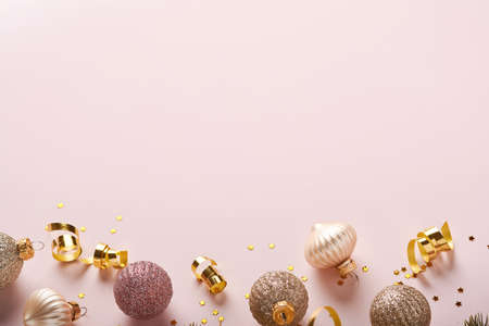 Christmas composition. Christmas gold gift or present box, gold baubles and confetti on pink...