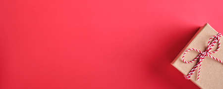 Christmas presents box. New Year or Christmas flat lay top view Xmas holiday celebration decoration red paper background with copyspace. Template mockup greeting card text designの写真素材