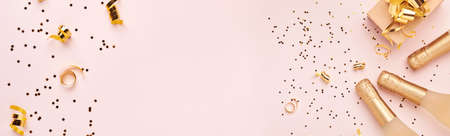 Christmas composition. Christmas pink gift or present box, gold baubles and confetti on pink background. Flat lay, top view. Magic Christmas greeting card. Border design. Mock up.の写真素材