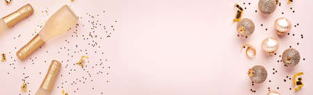 Champagne bottle, gift or present box and golden shiny sparkle star confetti on pink background. Christmas or New Year composition or card. Celebration flat lay. Party creative concept. Top view.の写真素材