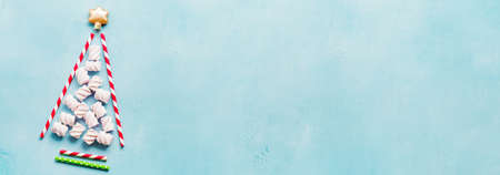 Christmas tree made of drinking colorful paper on blue background. New year concept.の写真素材