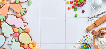 Easter baking background. Concept of cooking traditional festive food Easter gingerbread and bread on white background. Spring cooking time. Space for a text.の写真素材