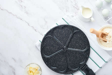 Empty frying pan black, skillet with stone nonstick coating for baking pancakes in shape of...