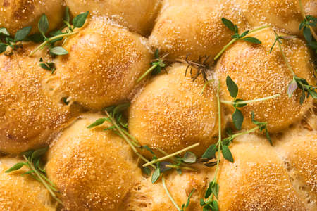 Bread texture roasted homemade bread buns with thyme. Traditional spelled sourdough bread cut into...