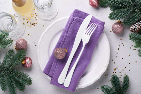 Christmas table setting white color with silverware, napkin trendy color very peri in 2022 Year,...