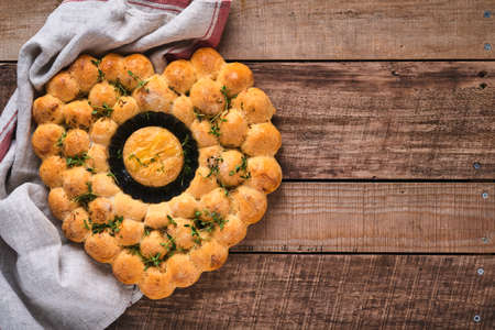 Roasted camembert cheese and homemade bread heart shaped and thyme on rustic background. French...
