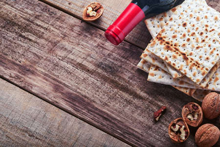 Matzah, red kosher and walnut. Traditional ritual Jewish bread on old wooden rustic background. Passover food. Pesach Jewish holiday of Passover celebration concept.の写真素材