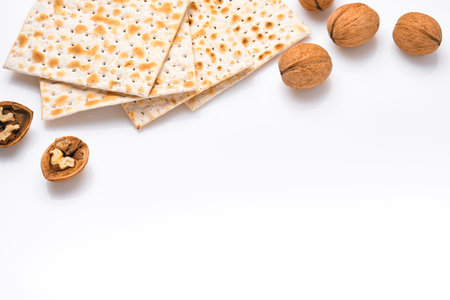 Matzah and walnut. Traditional ritual Jewish bread on isolated on white background. Passover food. Pesach Jewish holiday of Passover celebration concept. Traditional Jewish kosher matzo. Mock up.の写真素材