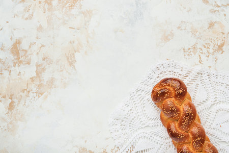 Challah bread. Sabbath kiddush ceremony composition. Freshly baked homemade braided challah bread for Shabbat and Holidays on white background, Shabbat Shalom. top view. copyspace.の写真素材