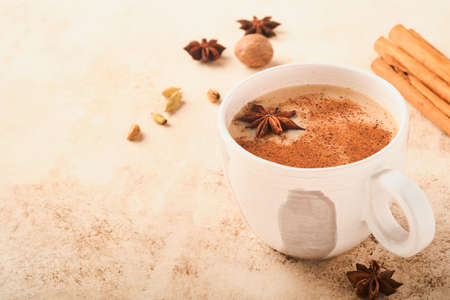Masala tea. Masala chai spiced tea with milk and spices on light warm beige background. Traditional Indian drink. copyspace. selective focus.の写真素材