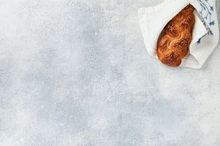 Sabbath kiddush ceremony composition. Challah bread. Freshly baked homemade braided challah bread for Shabbat and Holidays on light gray background, Shabbat Shalom. top view. copyspace.の写真素材
