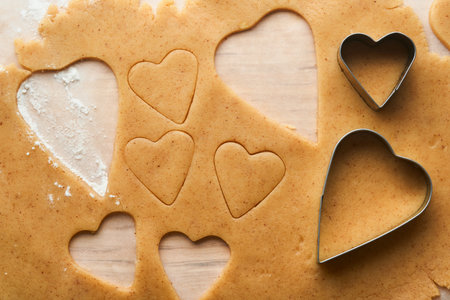 Baking ingredients and kitchen utensils on a white background top view. Preparing heart sugar cookies. Baking background. Flour, eggs, sugar, spices, and a whisk on the kitchen table. flat lay.の写真素材