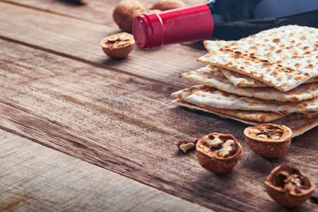 matzah and walnut. Traditional ritual Jewish bread on old wooden rustic background. Passover food. Pesach Jewish holiday of Passover celebration concept.の写真素材