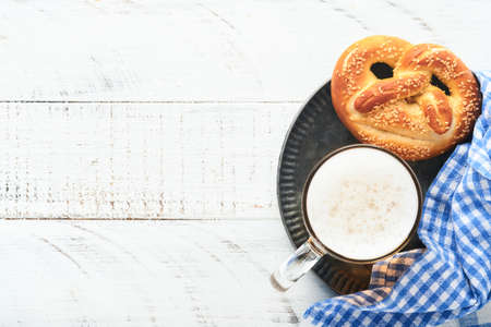 Bavarian pretzels and glass of lager beer. Oktoberfest food menu, traditional salted pretzels over...