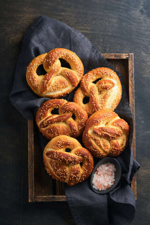 Bavarian pretzels and glass of lager beer. Oktoberfest food menu, traditional salted pretzels over...