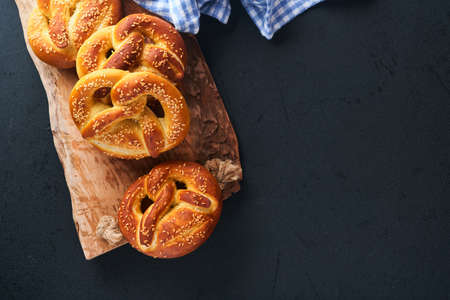 Bavarian pretzels and glass of lager beer. Oktoberfest food menu, traditional salted pretzels on...