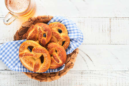 Bavarian pretzels and glass of lager beer. Oktoberfest food menu, traditional salted pretzels over...