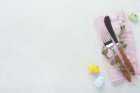 Easter table setting. Easter dinner with multicolored easter eggs. Elegance pastel and pink tablescapes. view from above. Christian religion tradition. Happy Easter concept. Mock up.の写真素材