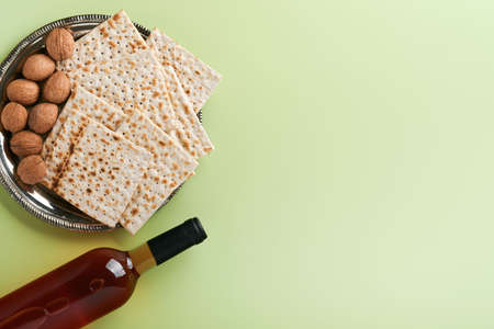 Passover celebration concept. Matzah, red kosher and walnut. Traditional ritual Jewish bread on...