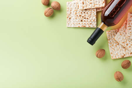Passover celebration concept. Matzah, red kosher and walnut. Traditional ritual Jewish bread on...