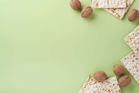 Passover celebration concept. Matzah, red kosher and walnut. Traditional ritual Jewish bread on...