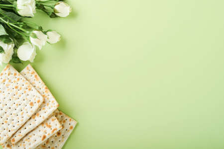 Passover celebration concept. Matzah, red kosher wine, walnut and spring beautiful rose flowers....