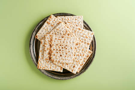 Passover celebration concept. Matzah, red kosher and walnut. Traditional ritual Jewish bread on...