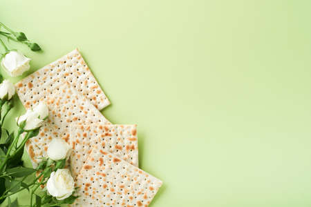Passover celebration concept. Matzah, red kosher wine, walnut and spring beautiful rose flowers....