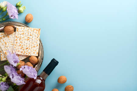Pesach Jewish holiday. Passover celebration concept. Matzah, red kosher wine and walnut. Traditional...