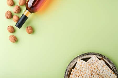 Passover celebration concept. Matzah, red kosher wine and walnut. Traditional ritual Jewish bread on...