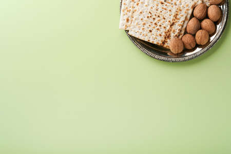 Passover celebration concept. Matzah, red kosher and walnut. Traditional ritual Jewish bread on...
