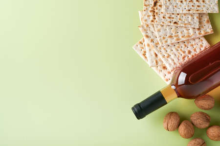 Passover celebration concept. Matzah, red kosher wine and walnut. Traditional ritual Jewish bread on...