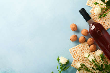 Passover celebration concept. Matzah, red kosher walnut and spring beautiful rose flowers....