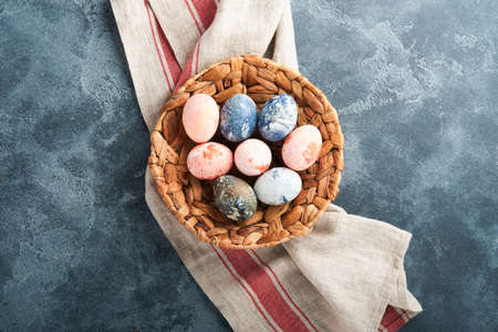 Easter eggs. Dyed Easter eggs with marble stone effect ref and blue color in rustic style on dark...