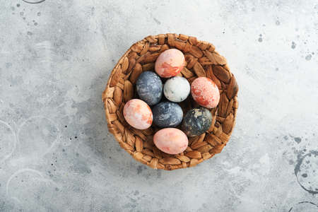 Easter eggs. Dyed Easter eggs with marble stone effect ref and blue color in rustic style on light gray stone background. Easter background. top view.の写真素材