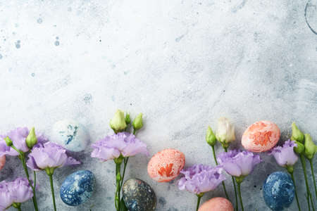 Easter eggs. Dyed Easter eggs with marble stone effect ref and blue color in rustic style on light gray stone background. Easter background. top view.の写真素材