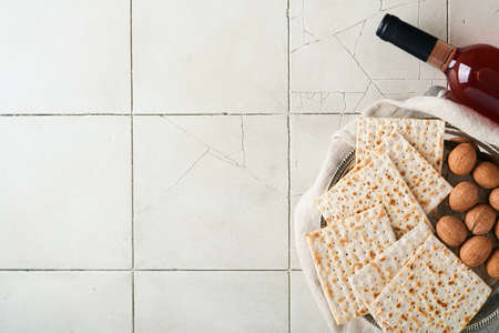 Passover celebration concept. Matzah, red kosher walnut. Traditional ritual Jewish bread on old gray...