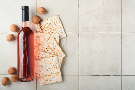 Passover celebration concept. Matzah, red kosher walnut. Traditional ritual Jewish bread on old gray...
