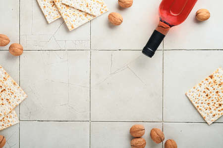 Passover celebration concept. Matzah, red kosher walnut. Traditional ritual Jewish bread on old gray...