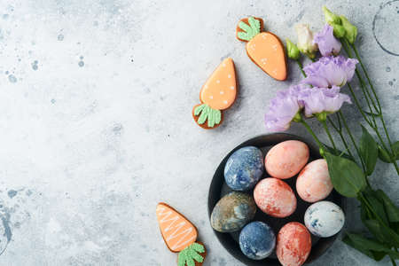 Easter eggs. Dyed Easter eggs with marble stone effect ref and blue color in rustic style on light gray stone background. Easter background. top view.の写真素材