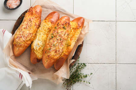 Baguette boats. Hot baked sandwich on baguette bread with ham, bacon, vegetables and cheese on...