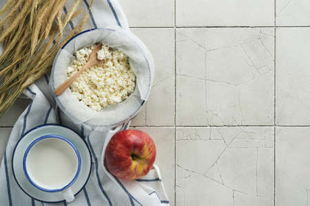 Shavuot jewish holiday celebration. Milk and cheese, ripe wheat and fruits, cream old cracked tile...