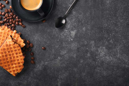 Coffee and dutch waffles. Espresso coffee and dutch waffles or syrupwaffles cookies with chocolate on old on black concrete table. Perfect syrupwaffles cookies for Breakfast . top view. Mock up.の写真素材